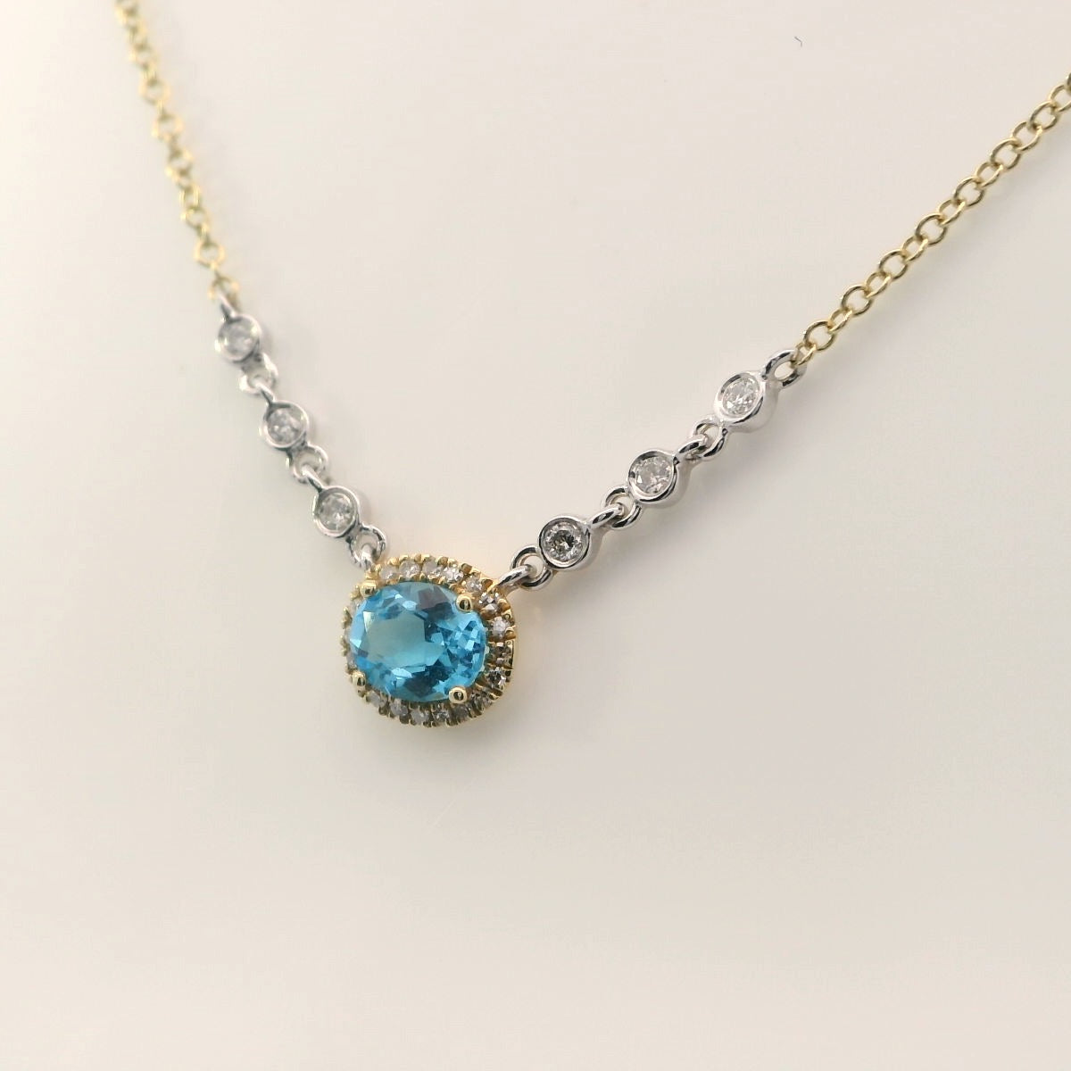 Blue Topaz surrounded with a dimond halo, 6 bezel diamonds.  MeiraT