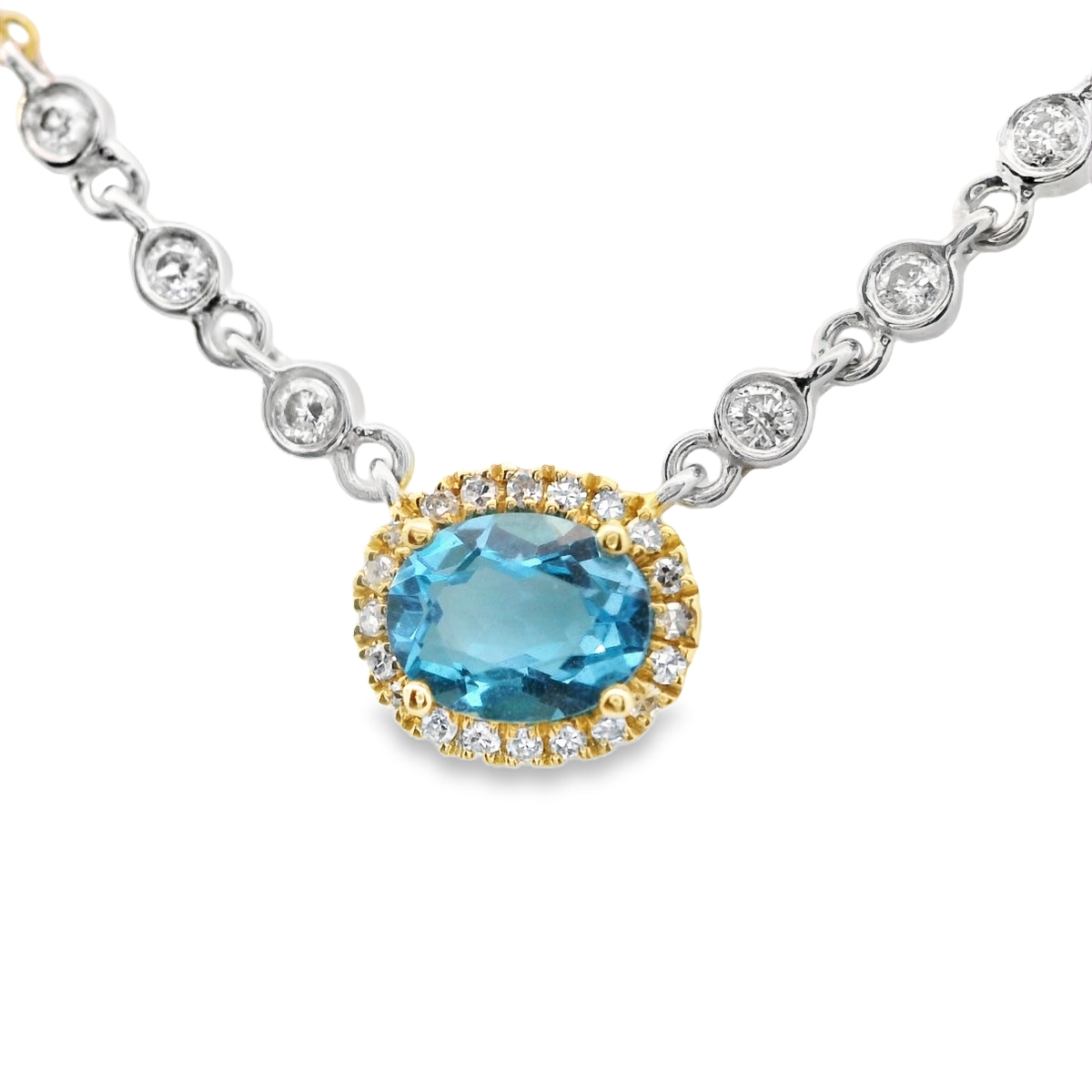 Blue Topaz surrounded with a dimond halo, 6 bezel diamonds.  MeiraT
